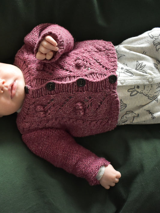 Image showing Sofie's Cardigan Baby Knitting pattern by Katerina Rieckel, knitted in pink color and dk-weight yarn.