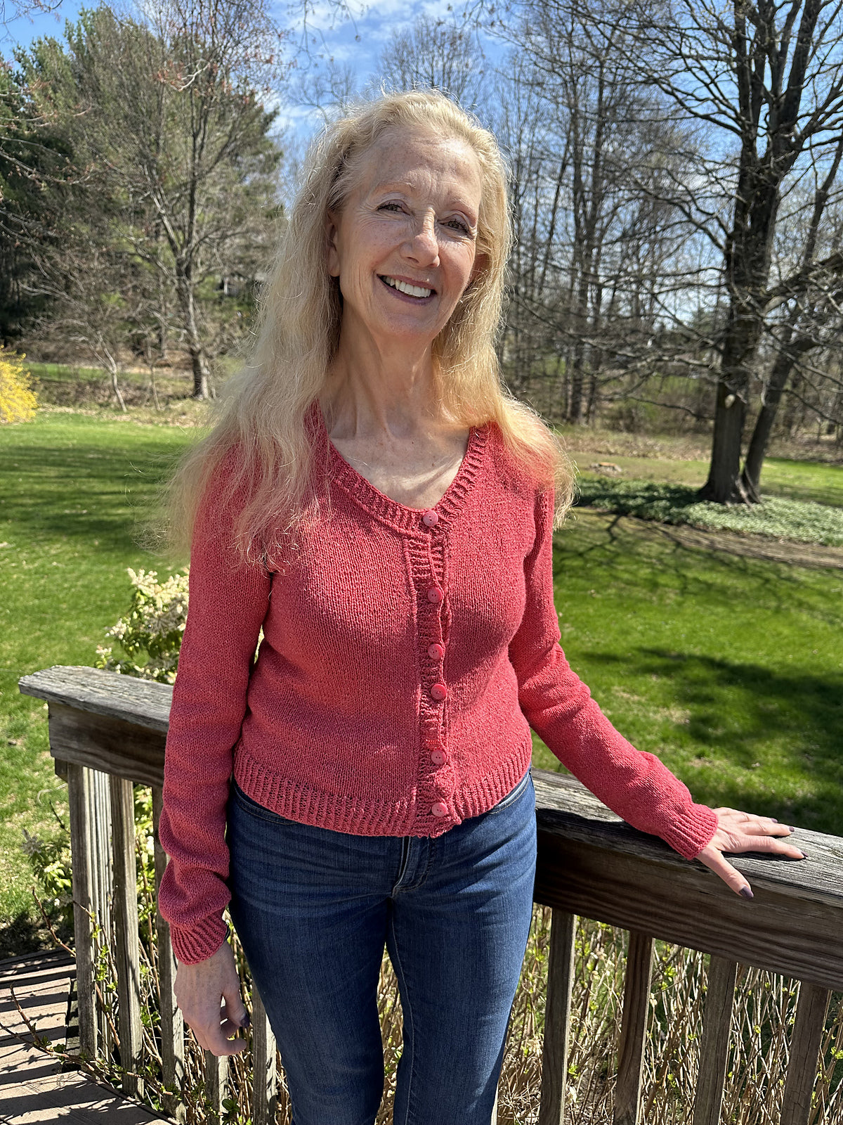 Photo of Curnynla wearing her pink version of the Deepwood Cardigan knitting pattern.