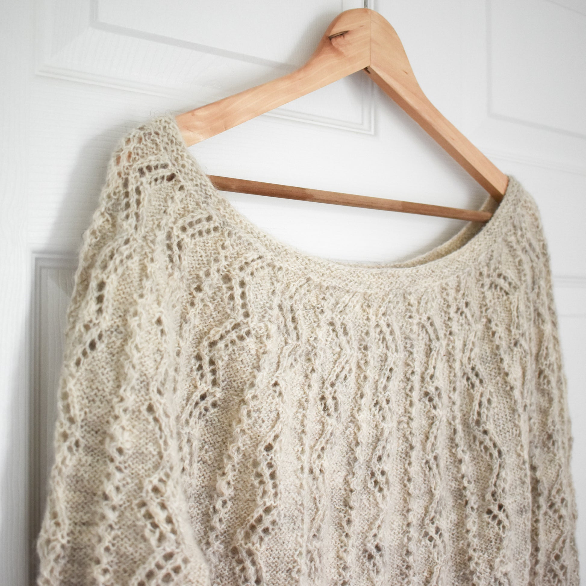 Beige top down sweater knitting pattern with lace.