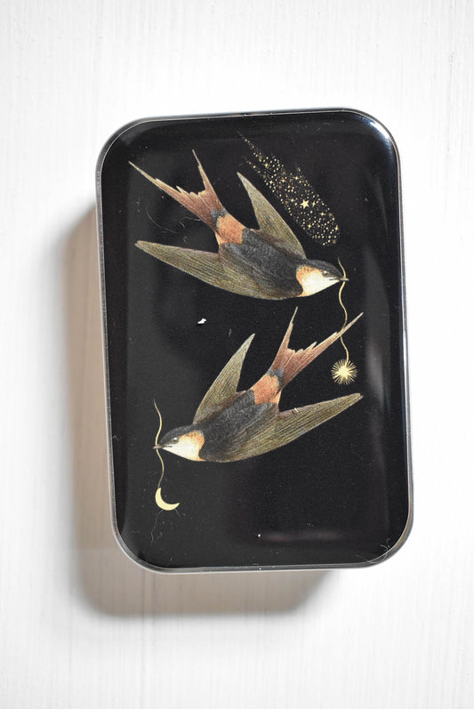 Celestial swallows knitting notions tin with stitch markers and a progress keeper.