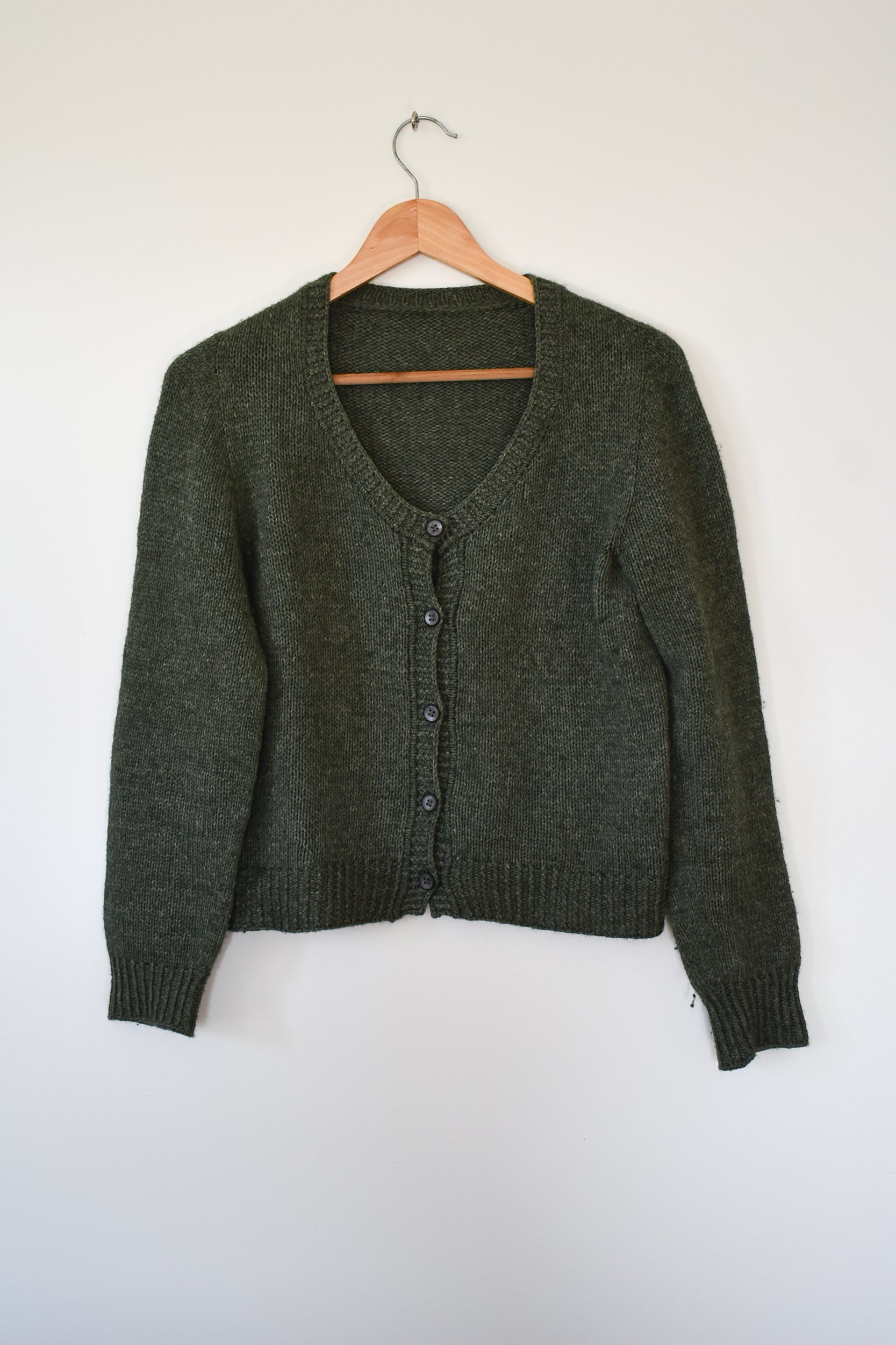 A photo showing the Deepwood Cardigan knitting pattern.