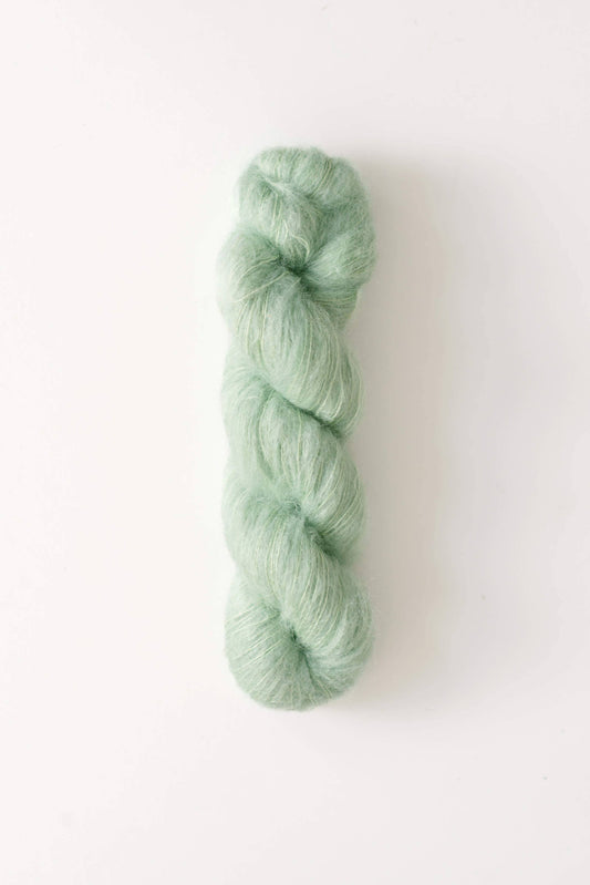 Mint green skein of Dove mohair silk yarn.