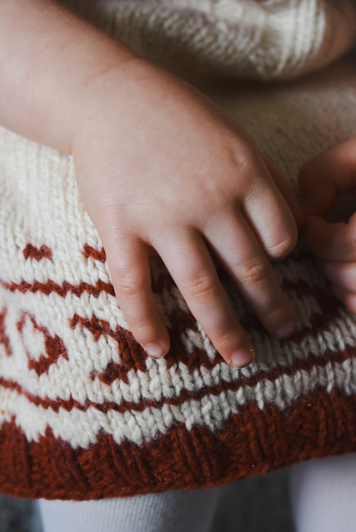 Close up of a fair isle christmas knitting pattern for babies.