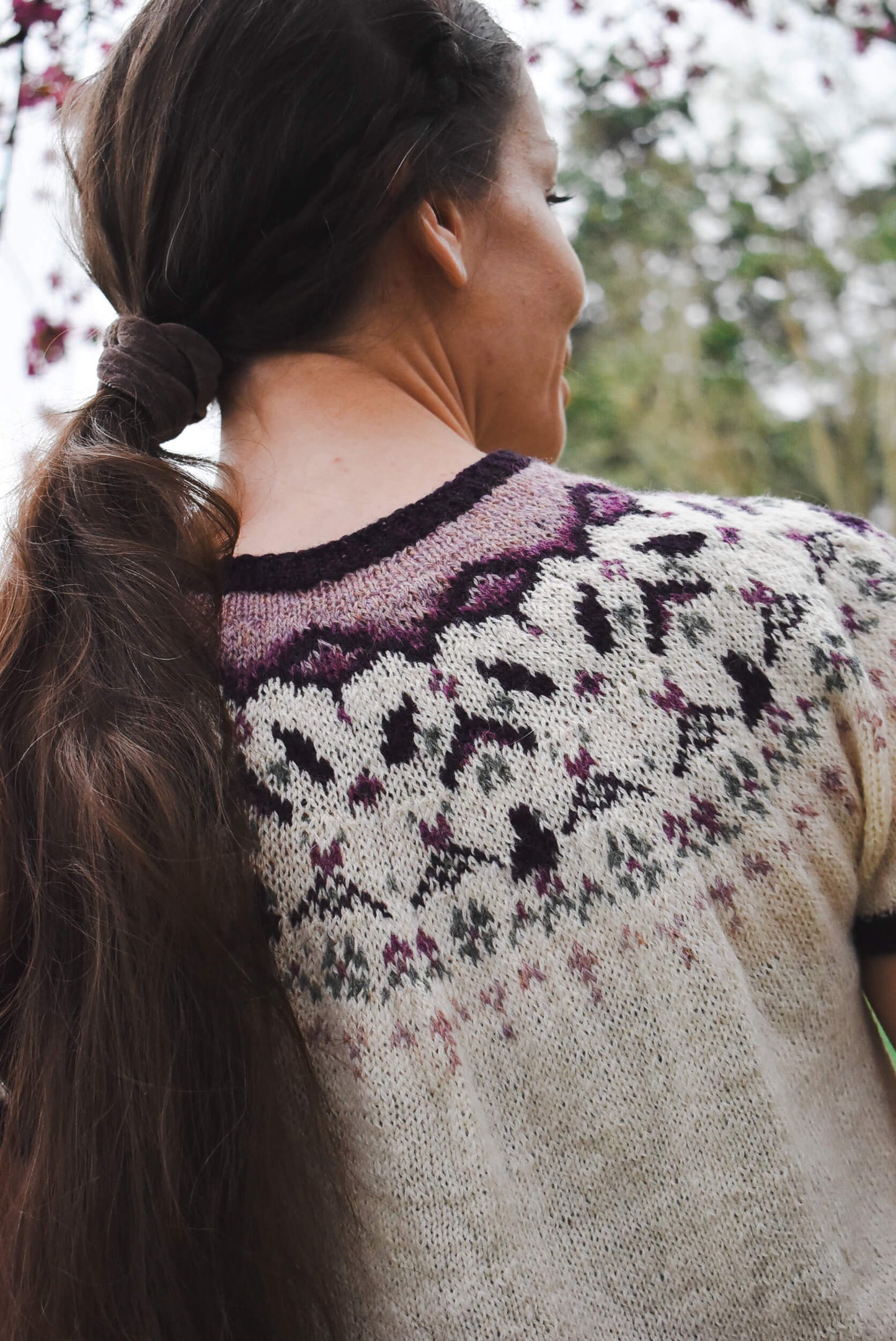 Fair isle yoke sweater knitting pattern with spring motifs.