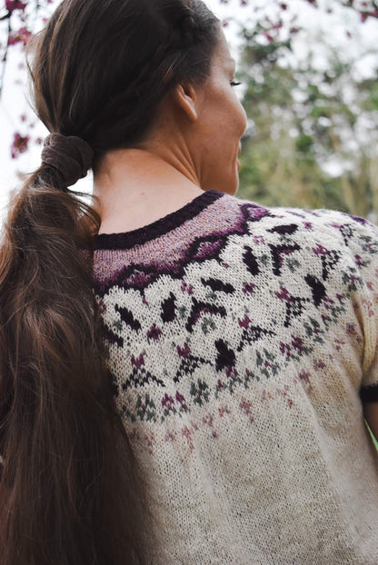 Fair isle yoke sweater knitting pattern with spring motifs.