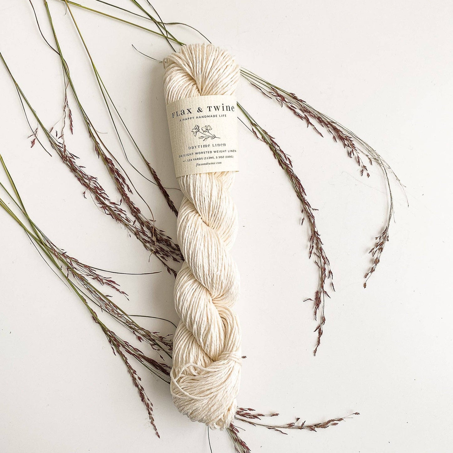 Flax & Twine DK light worsted linen yarn great for summer knitting and crochet, a skein shown in Ivory color.