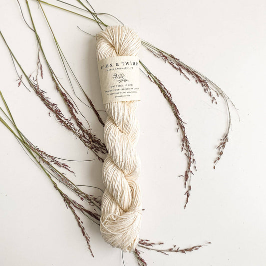 Flax & Twine DK light worsted linen yarn great for summer knitting and crochet, a skein shown in Ivory color.