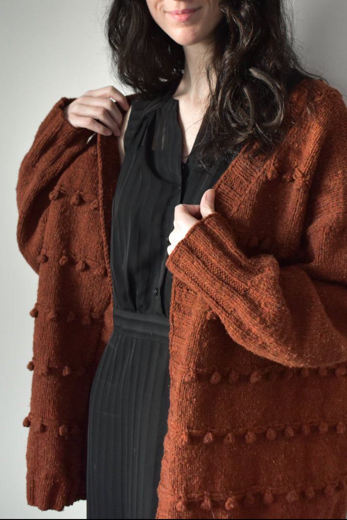 Oversized textured cardigan knitting pattern in orange color.