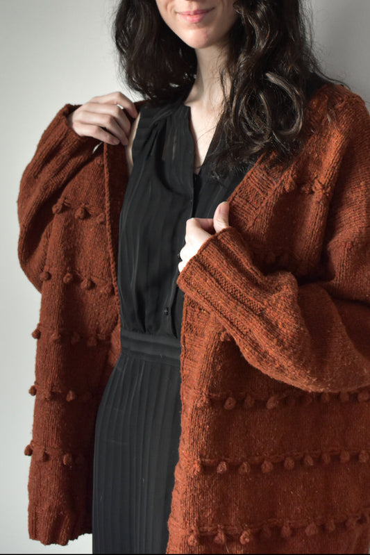 Oversized textured cardigan knitting pattern in orange color.