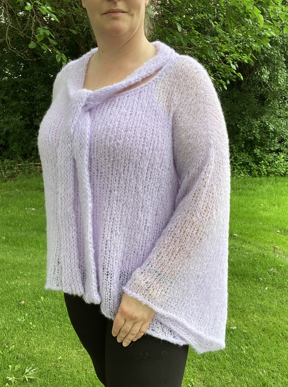 Completed mohair blouse knitting project by Belinda in lavender color, worn outside.