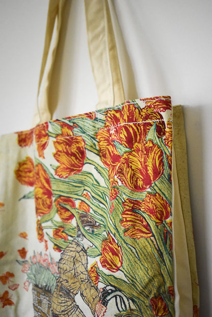 Floral tote bag with red tulips on a white background.