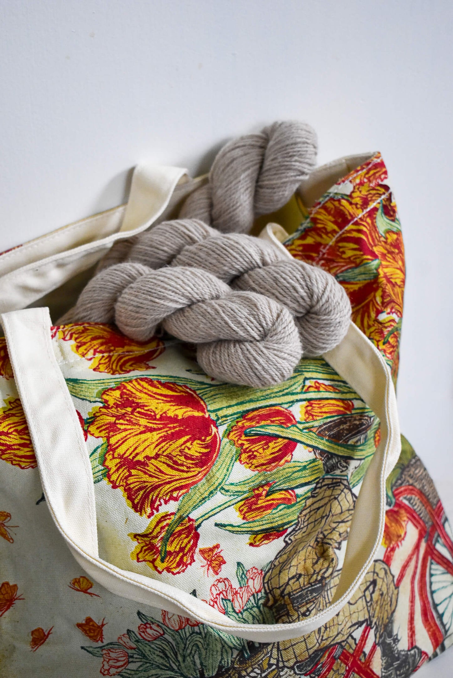 Large canvas knitting tote with tulips illustration.
