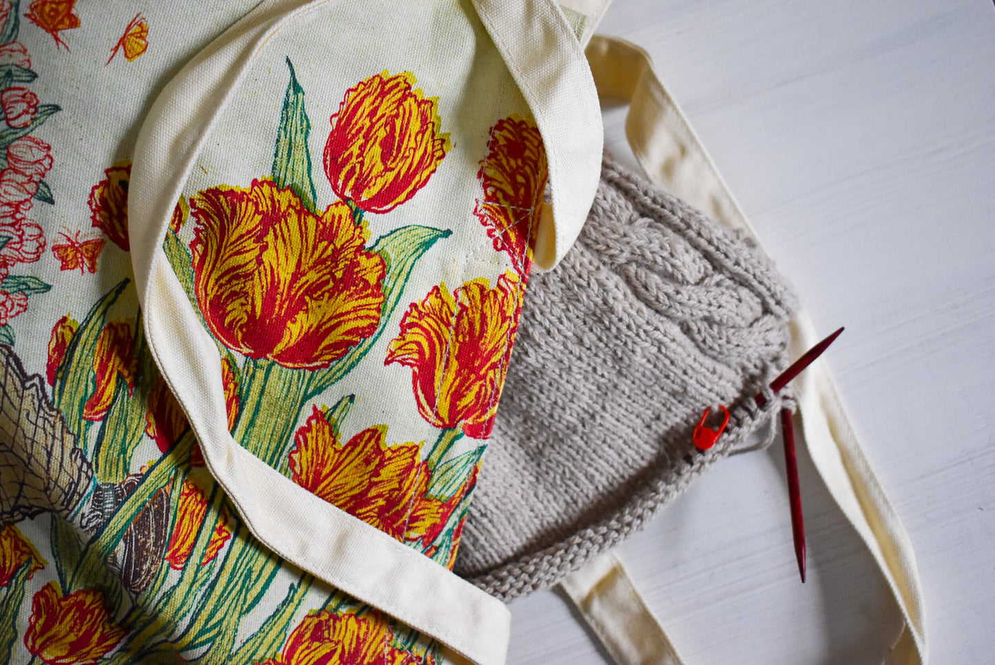 Project bag with a floral design and knitting.