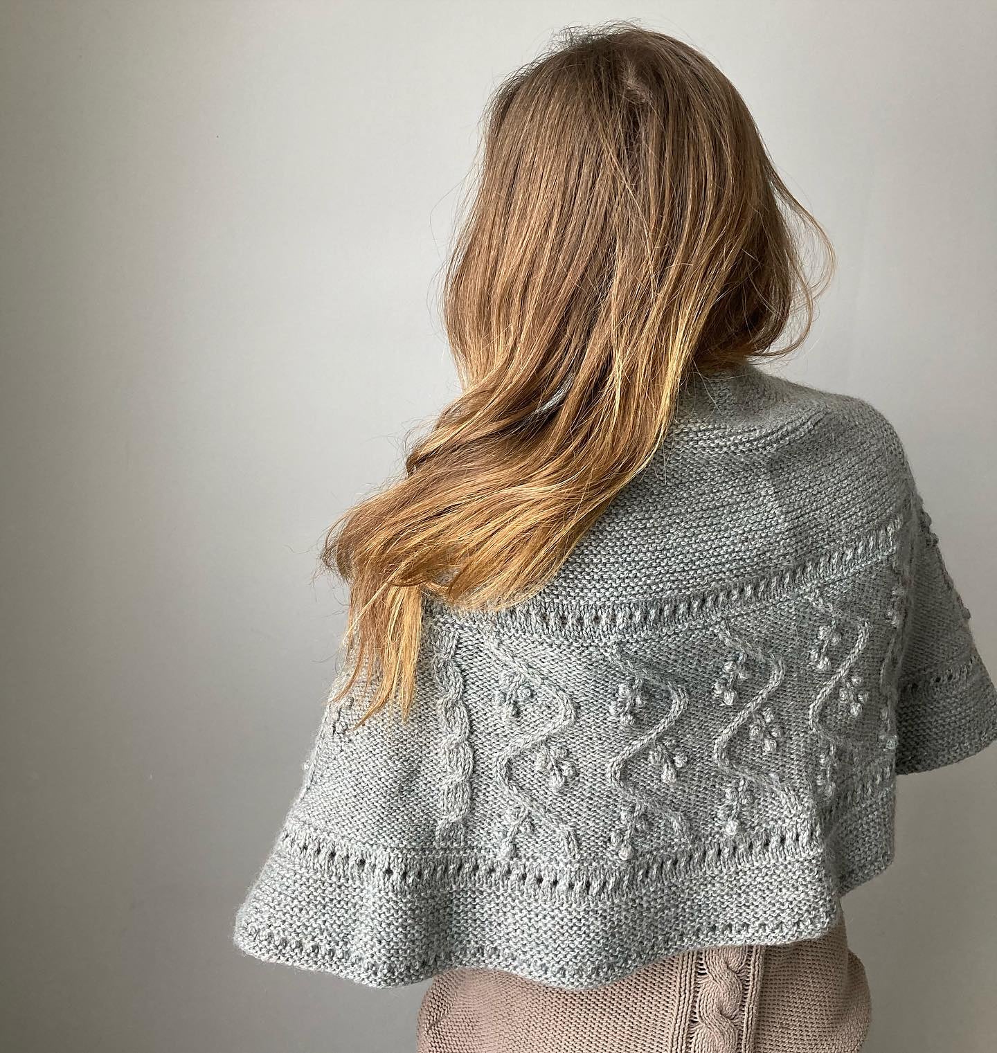 Crescent shawl knitting pattern with intricate cables, bobbles and lace.