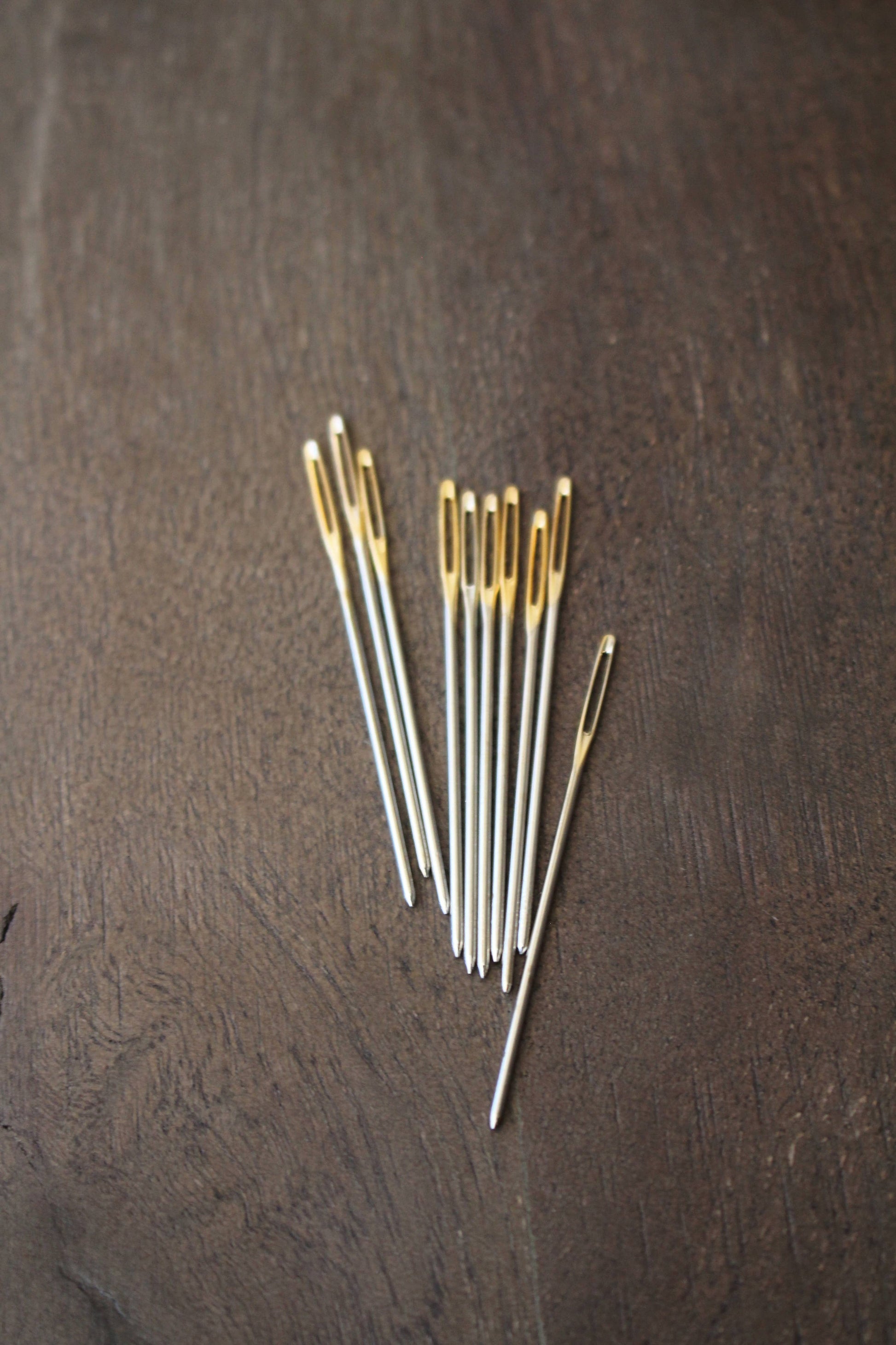 Large needle for weaving in yarn ends.