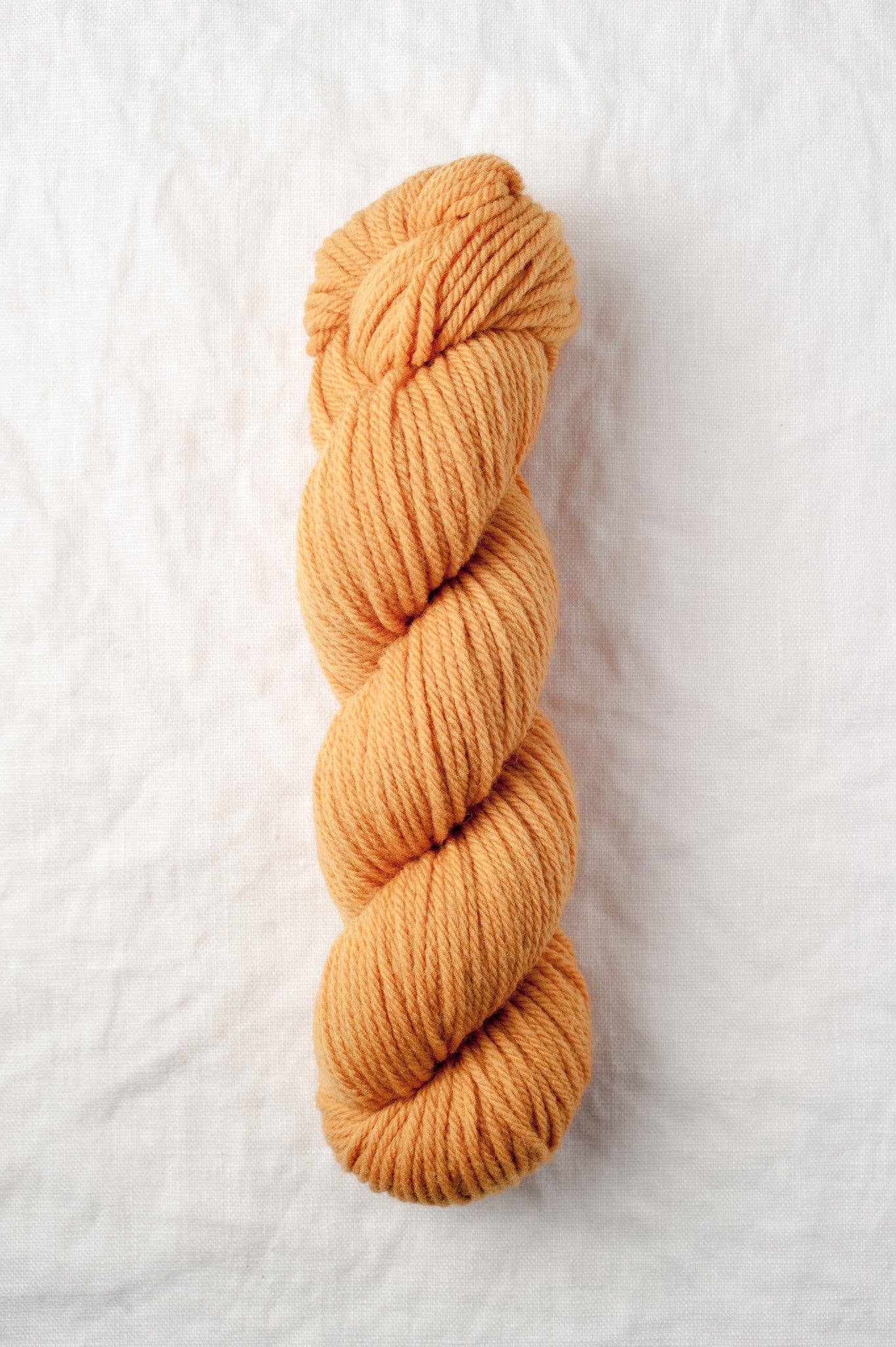 Lark 100% Wool Worsted Weight Yarn in Apricot.