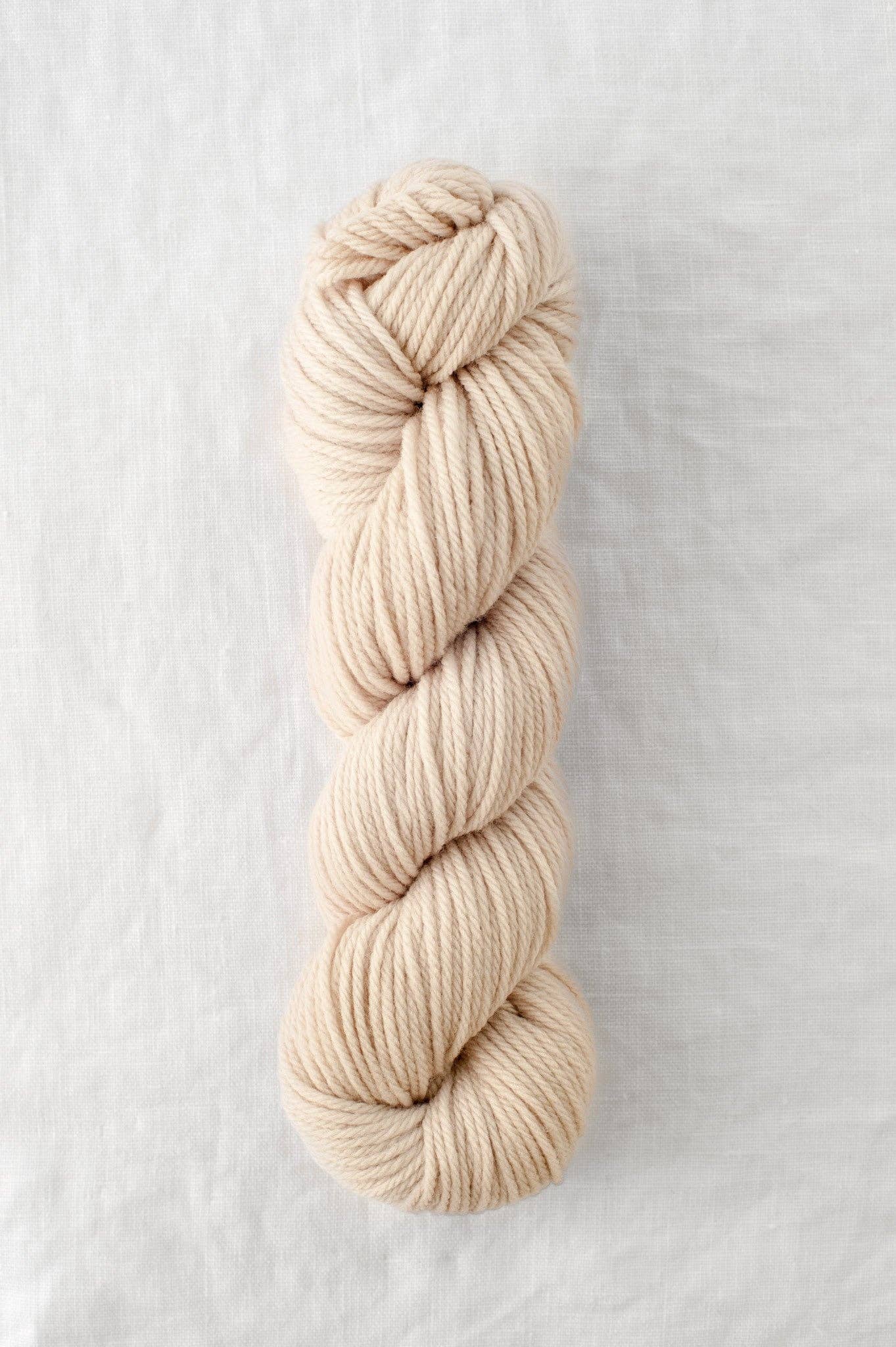 Lark 100% Wool Worsted Weight Yarn in beige color.