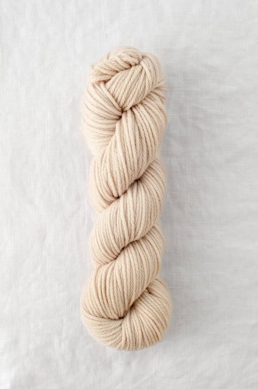 Lark 100% Wool Worsted Weight Yarn in beige color.