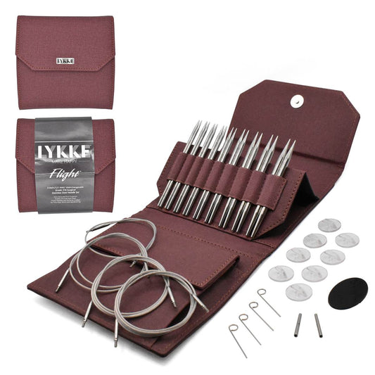 Surgical steel knitting needle set with swivel cords and maroon case.