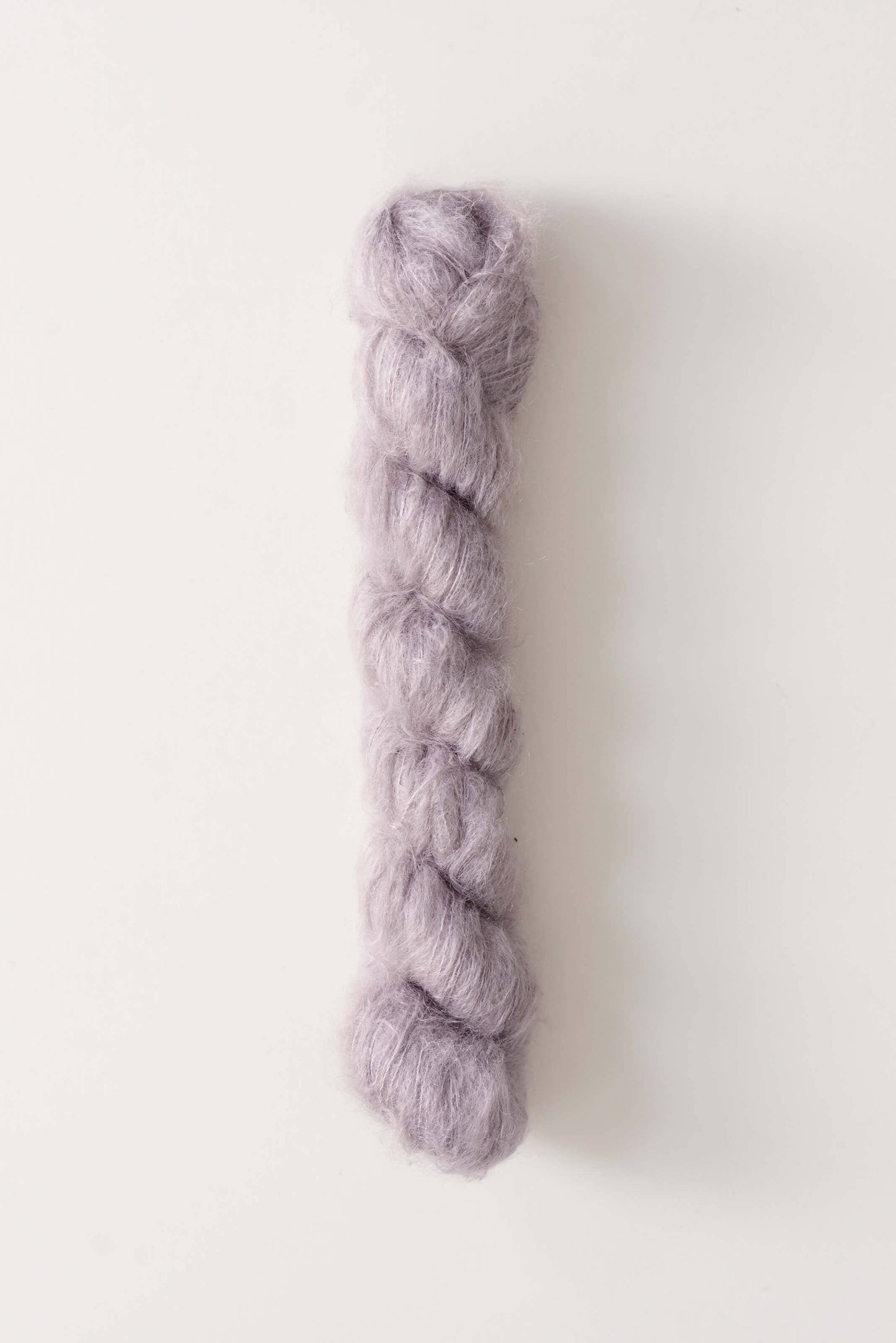 Silk mohair yarn by Quince & Co. in mauve color.