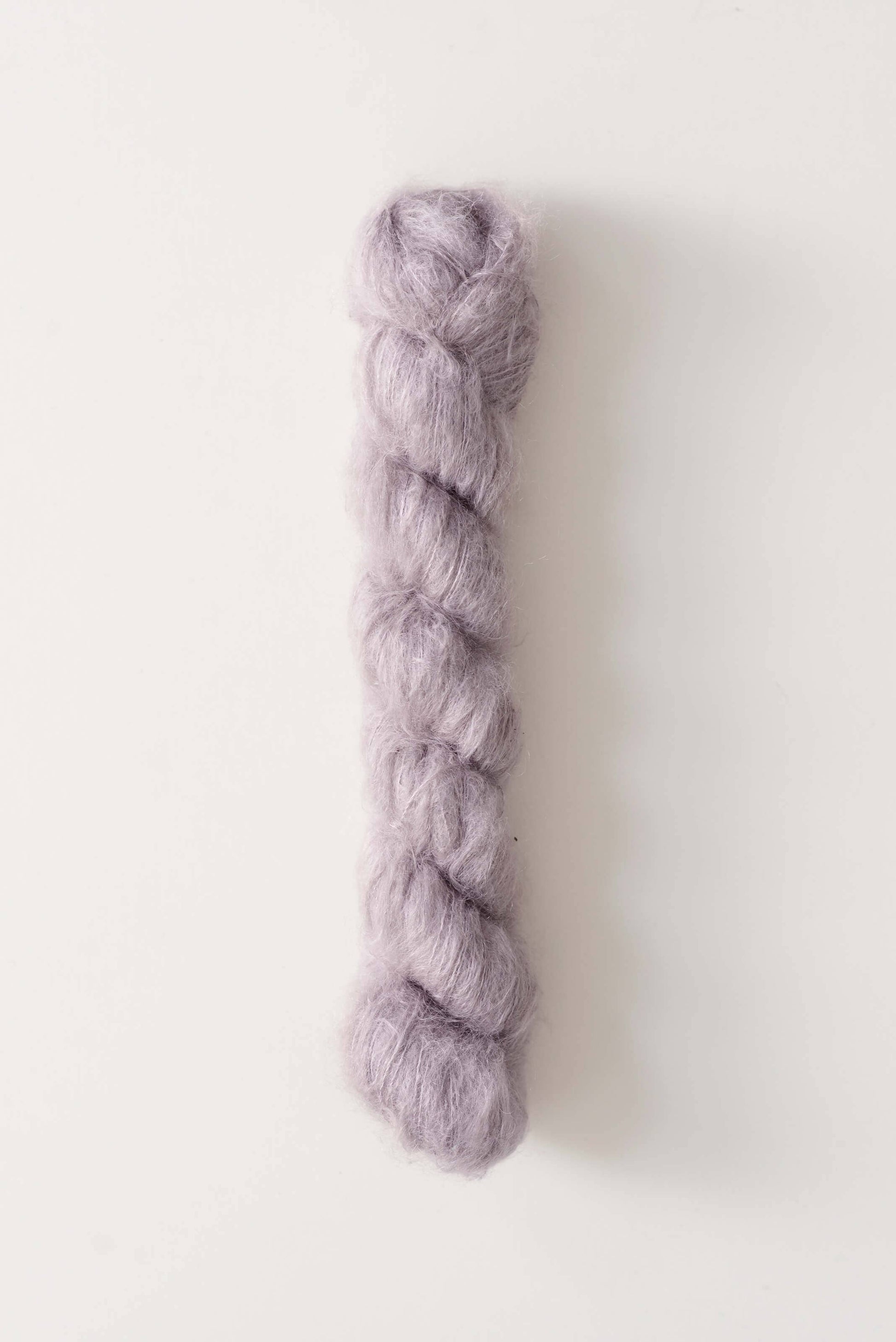 Silk mohair yarn by Quince & Co. in mauve color.