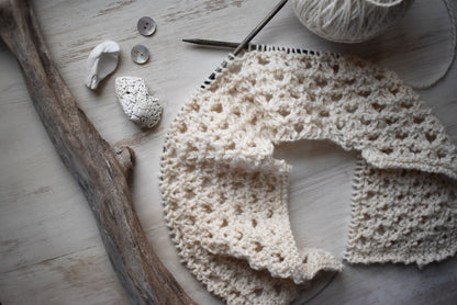 Hand-knitted lace garment resembling crochet.