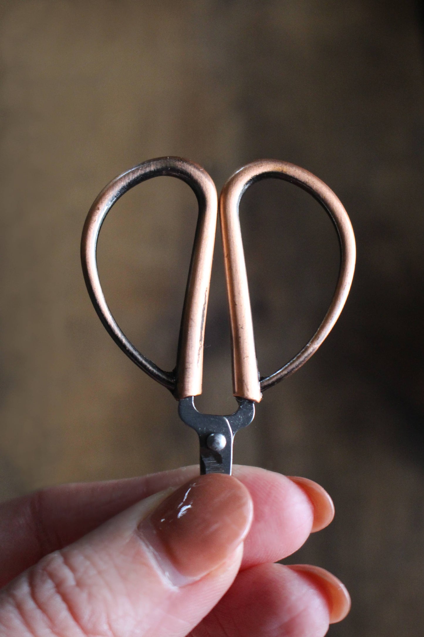 Small garden-style scissors for cutting yarn.