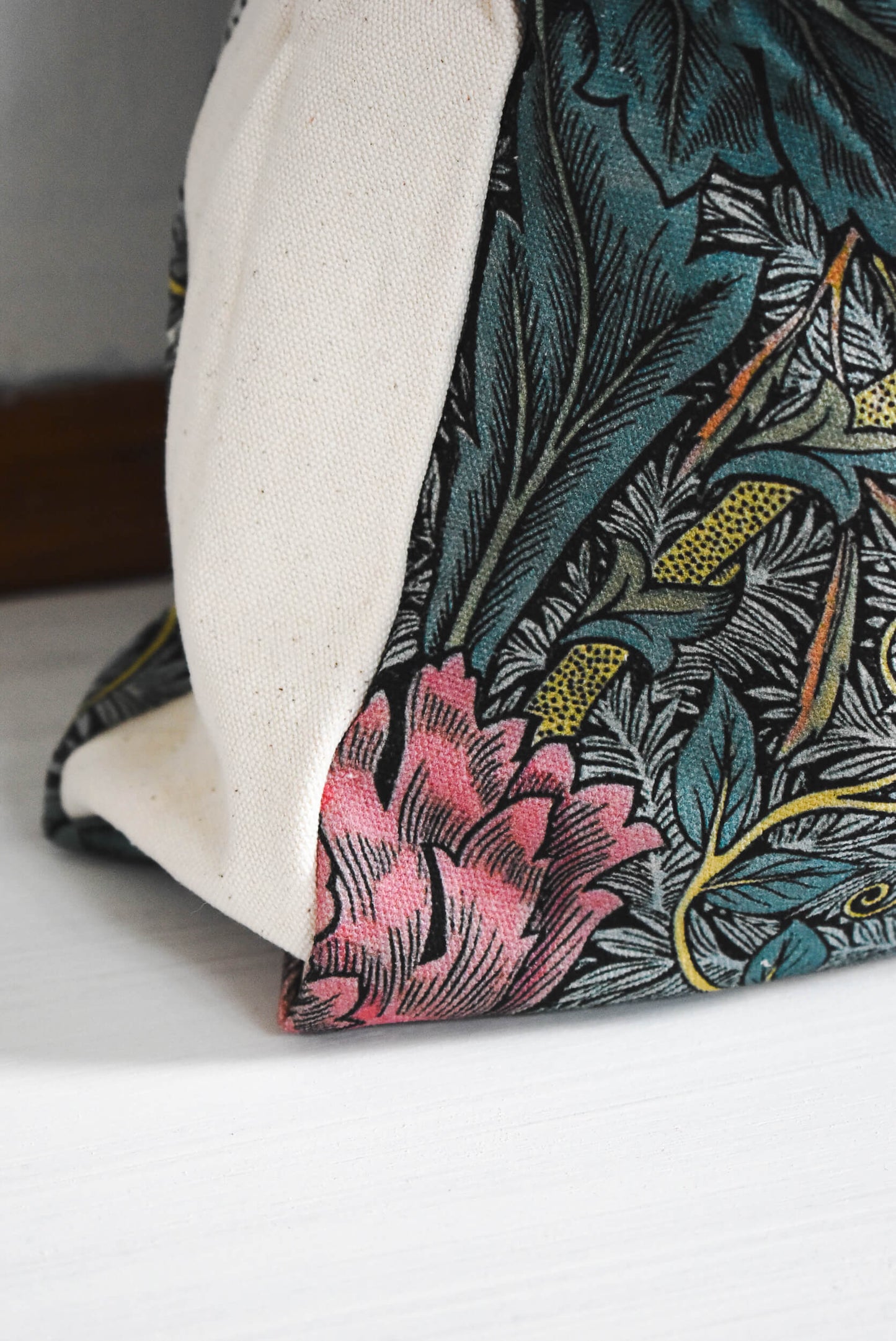 Floral fabric on a project bag with pink flowers and green leaves.