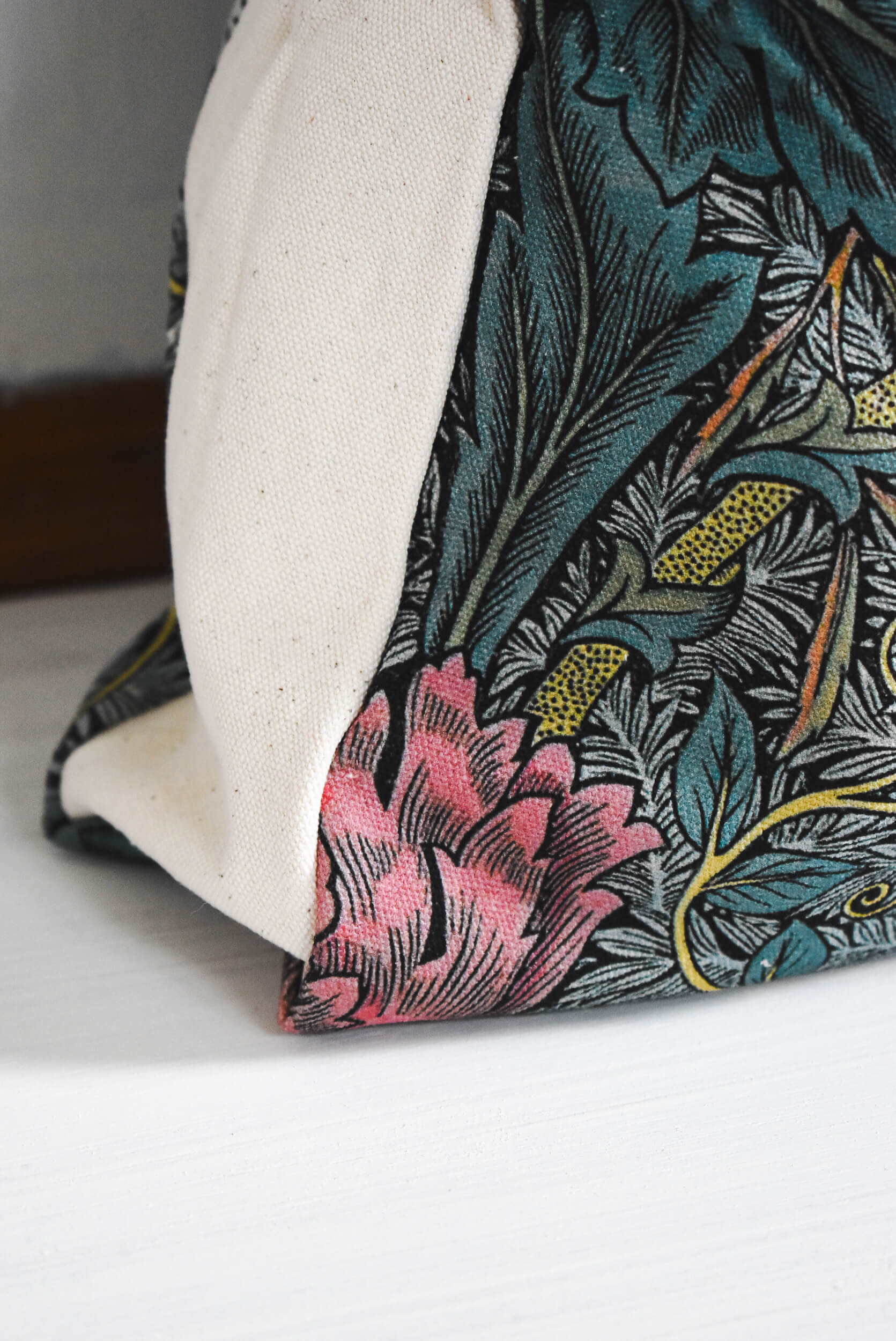 Floral fabric on a project bag with pink flowers and green leaves.