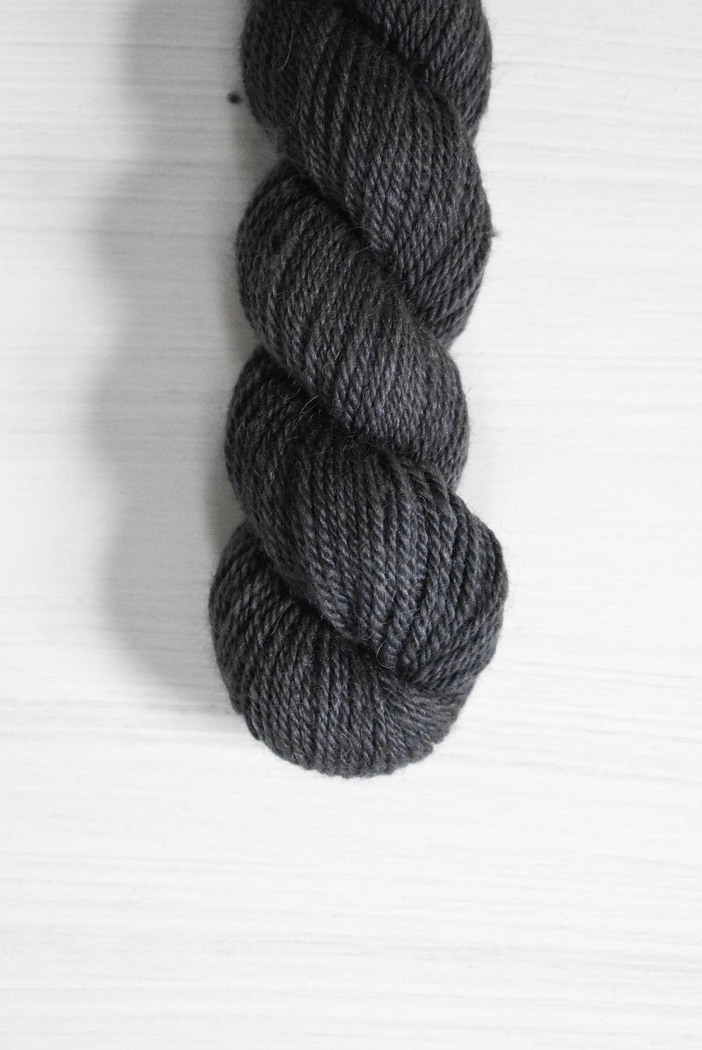 Navy blue skein of baby alpaca wool yarn.