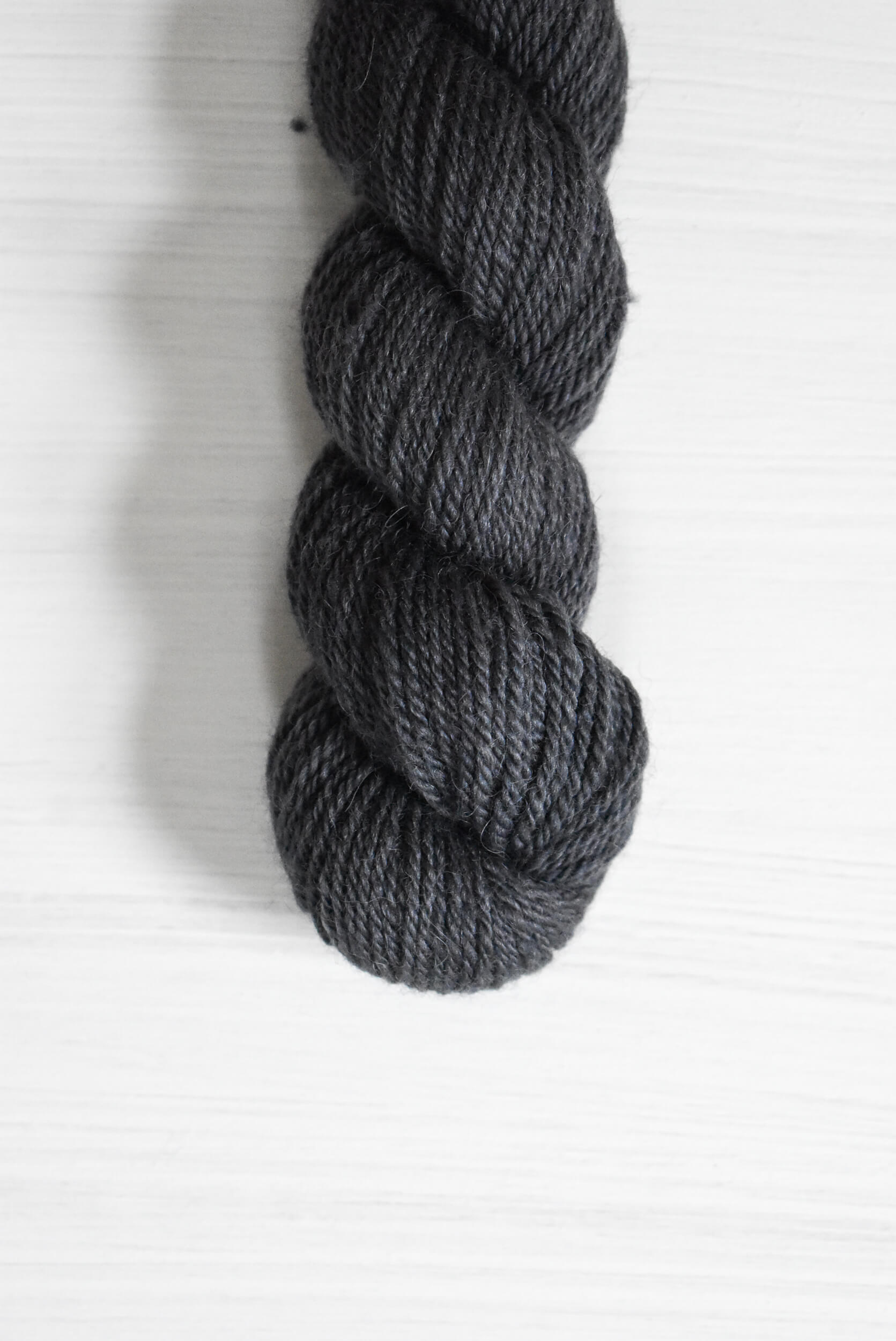 Navy blue skein of baby alpaca wool yarn.