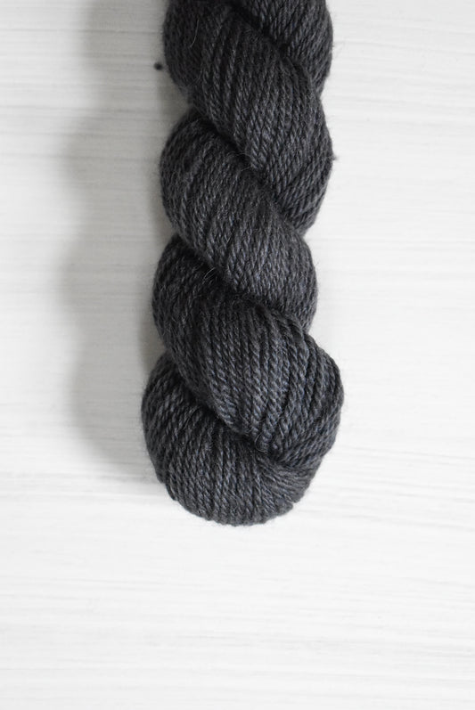 Navy blue skein of baby alpaca wool yarn.
