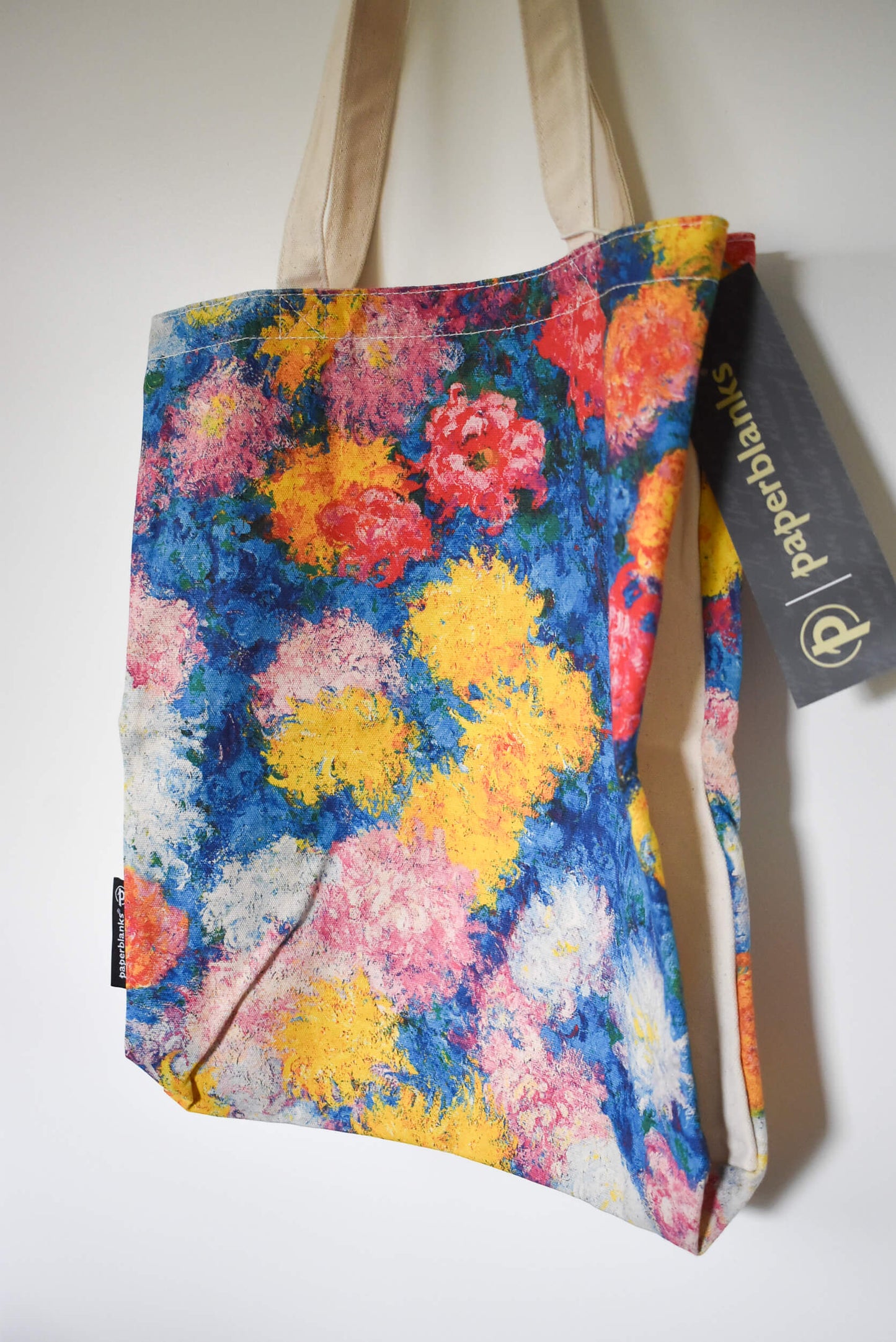 Floral tote bag with a visible brand tag.