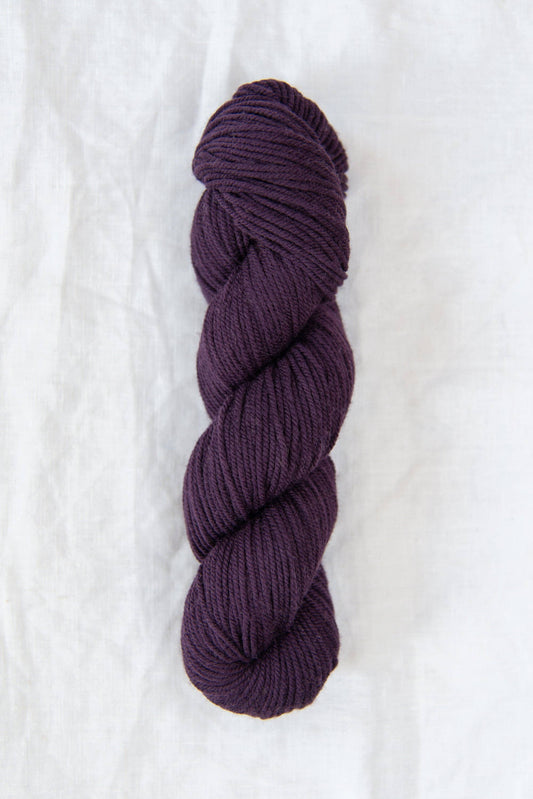DK weight aubergine wool yarn.