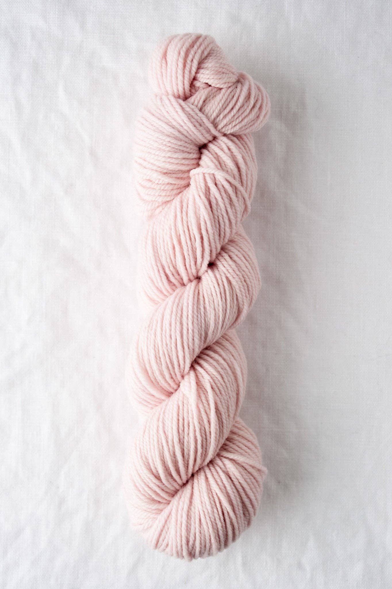 DK weight blush pink yarn, 100% American wool.