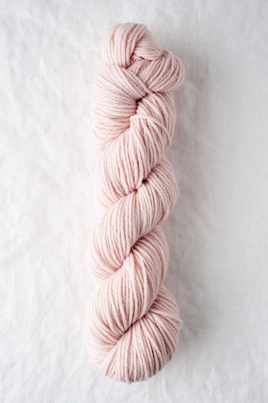 DK weight blush pink yarn, 100% American wool.