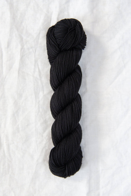 Black skein of Chickadee DK weight 100% American wool yarn.