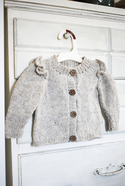 Ruffle baby cardigan knitting pattern for babies and toddlers.