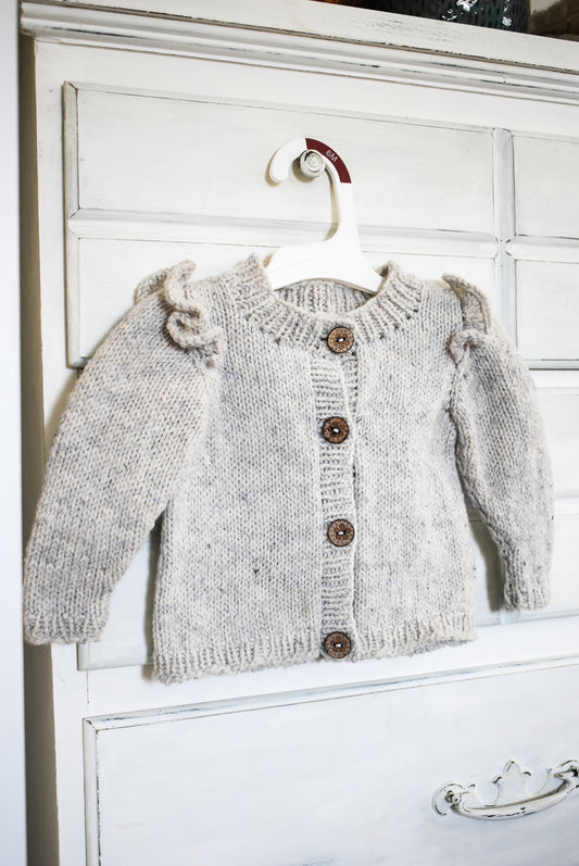Ruffle baby cardigan knitting pattern for babies and toddlers.