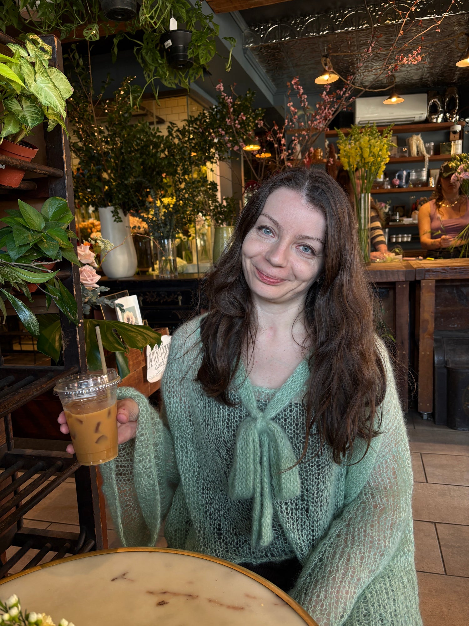 Silk Mohair blouse knitting pattern finished project worn in a cafe.