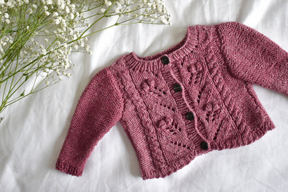 Image showing Sofie's Cardigan Baby Knitting pattern project laid flat on a white sheet.