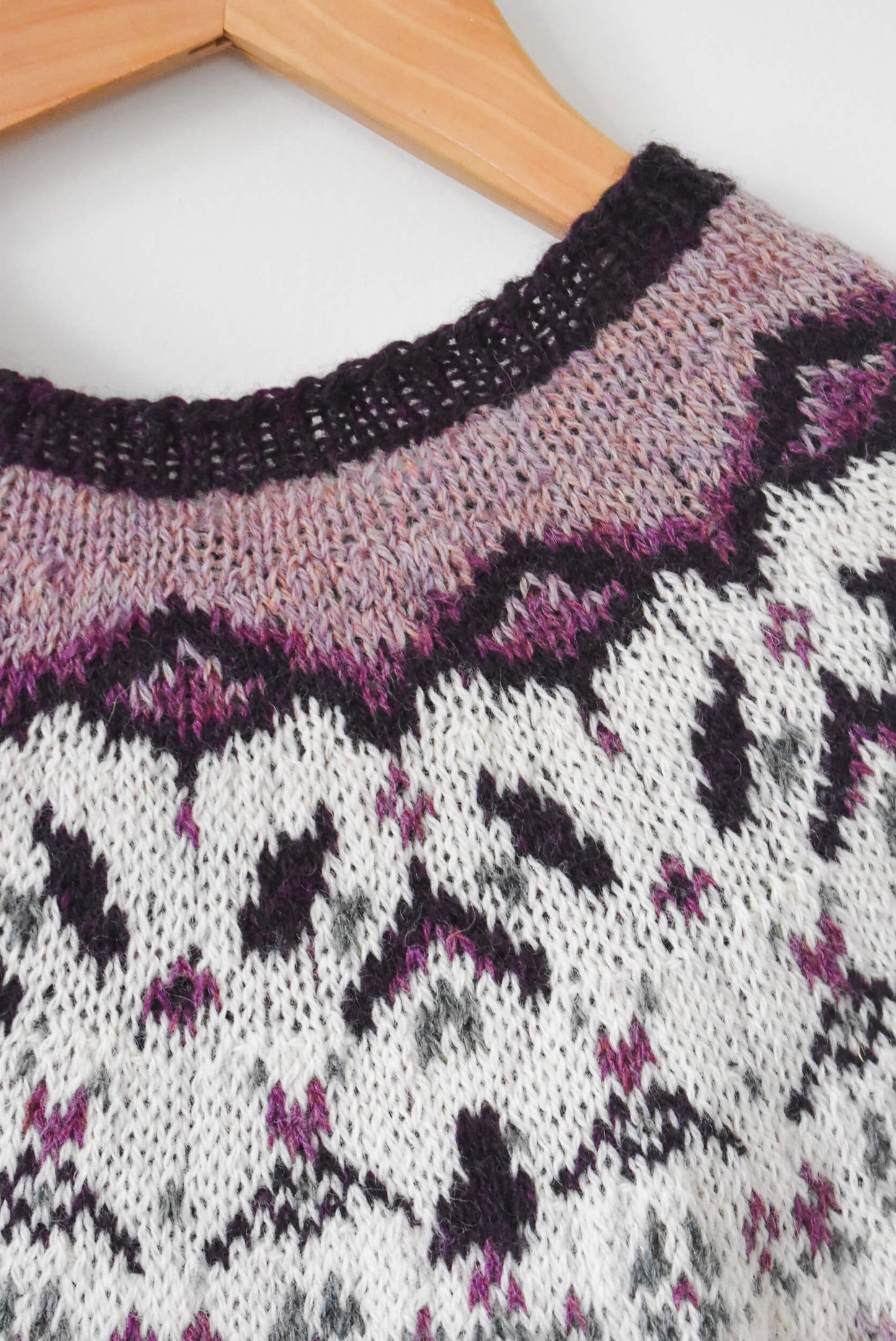 Close-up of a knitted sweater with a stranded knitting pattern.