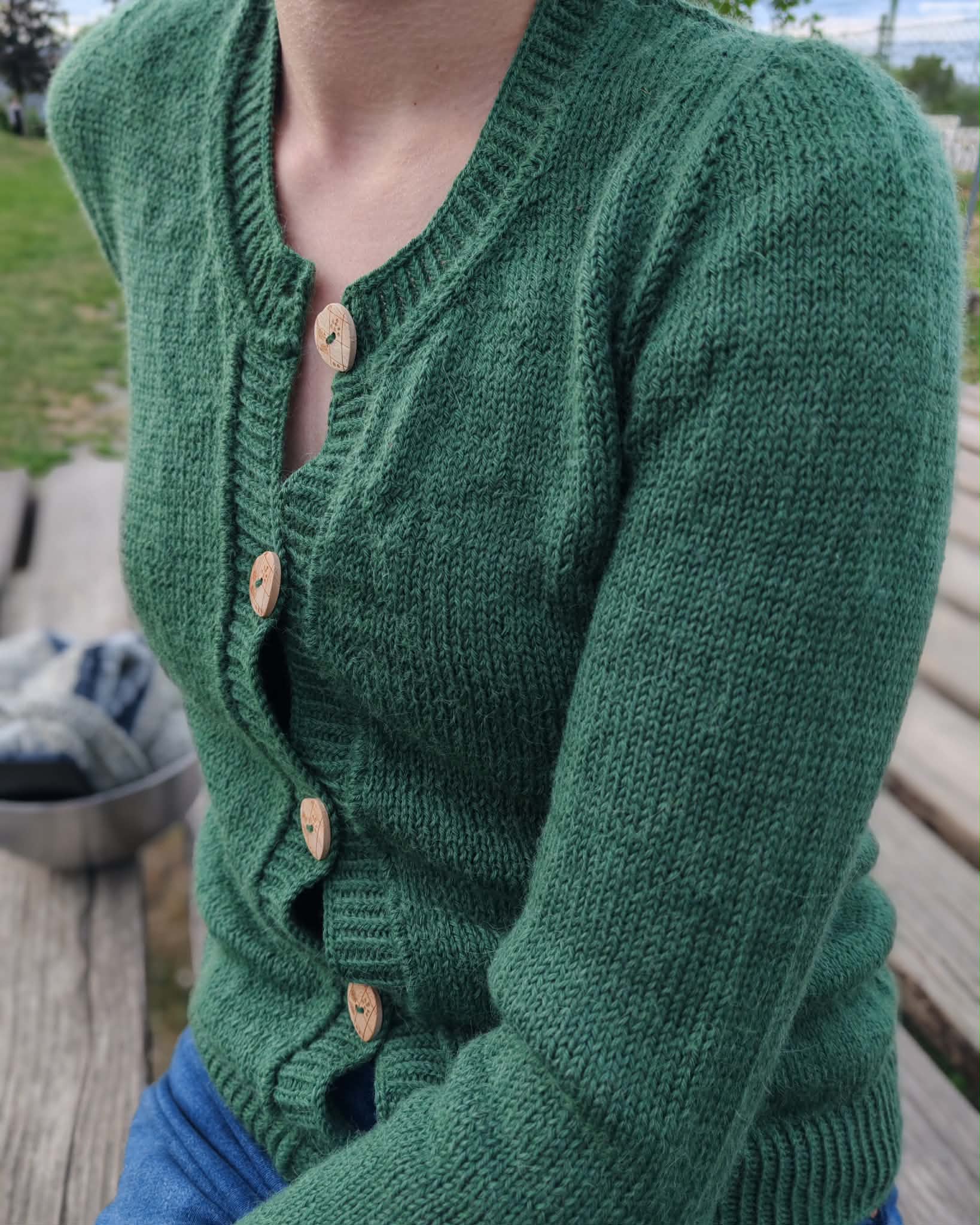 Green version of the Deepwood Cardigan knitting pattern by Strickerbecca.