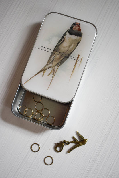 Swallow Knitting Notions Tin With Stitch Markers and a progress keeper.