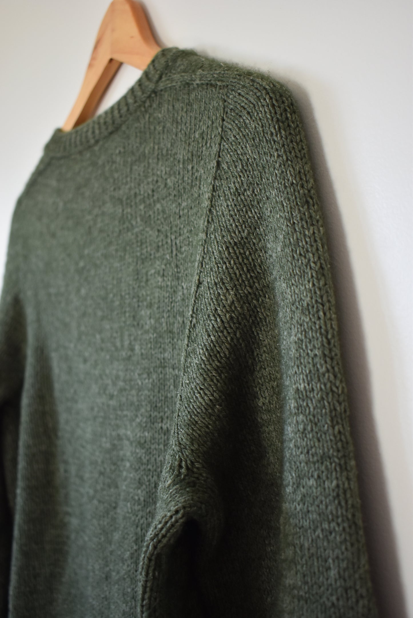 Green sweater knitting pattern created with a contiguous method.