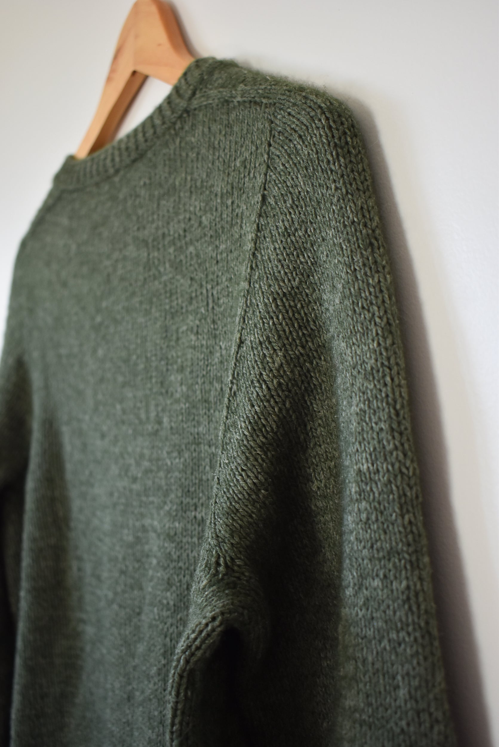 Green sweater knitting pattern created with a contiguous method.