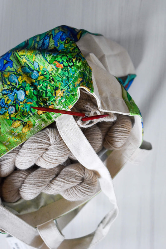 Knitting bag with yarn and knitting needles.