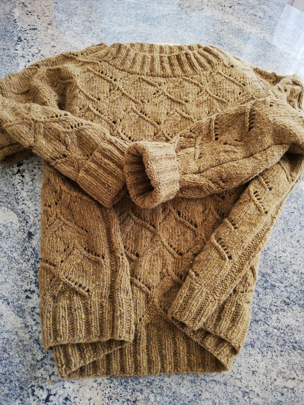 Waterscapes Pullover pattern worked in a golden yellow wool yarn.