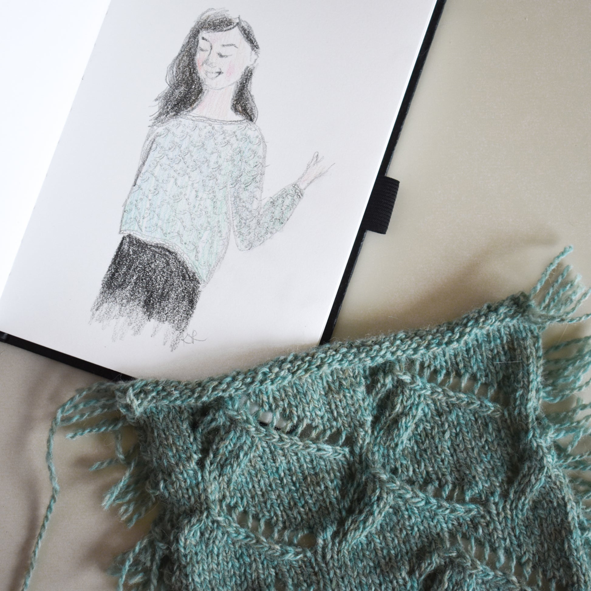 A photo showing a knit swatch and a hand drawn sketch of the Waterscapes Pullover knitting pattern.