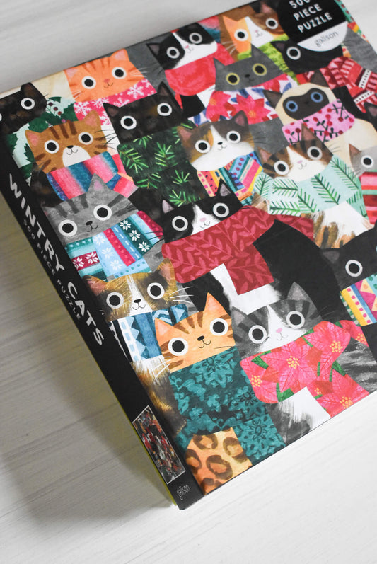 Cozy puzzle with colorful cat illustrations.